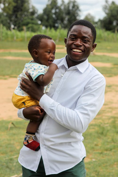 Free Smiling Father Holding Son Stock Photo