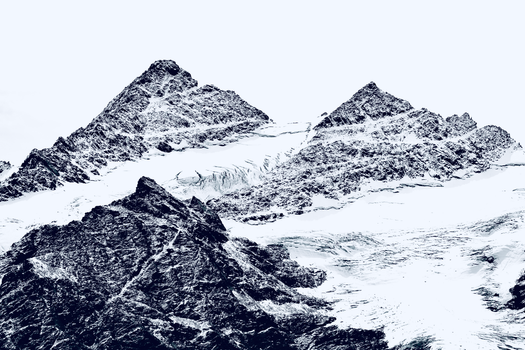 Breathtaking view of snowy mountain peaks, showcasing winter's majesty and serene beauty.