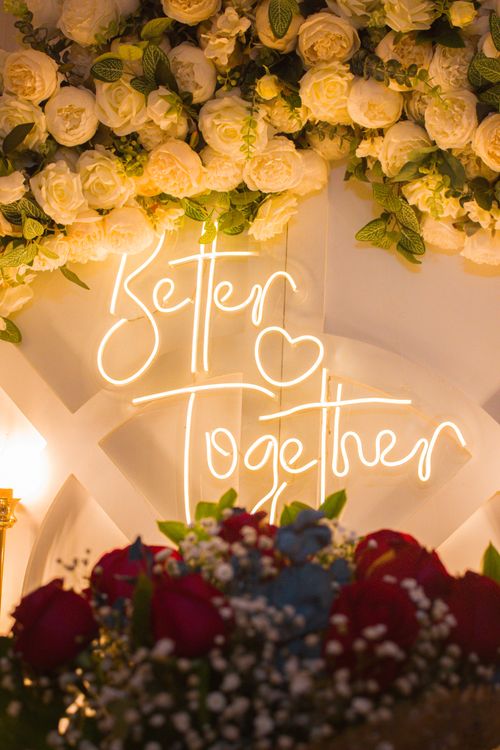 Free Beautiful floral arrangement with 'Better Together' neon sign at night. Stock Photo