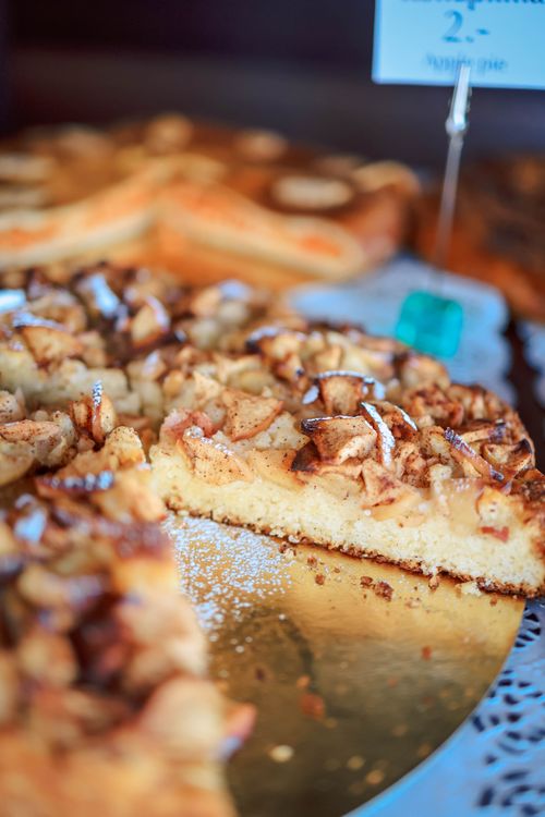 Free Warm and inviting apple cake slice dusted with powdered sugar, showcasing a homemade dessert. Stock Photo
