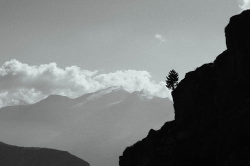 Free Silhouetted Rocky Cliff in Mountains  Stock Photo