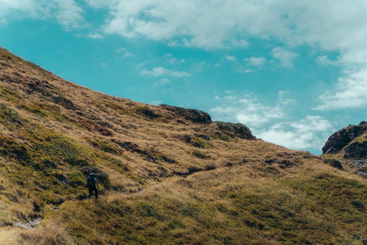 A Man Hiking A Mountain