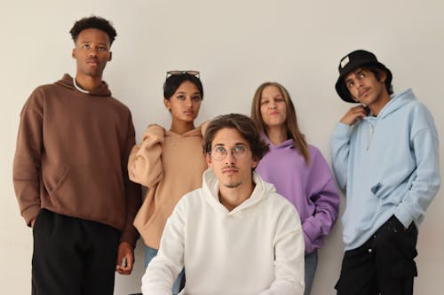 Photo of a Group of Young People Wearing Hoodies in Different Colors 
