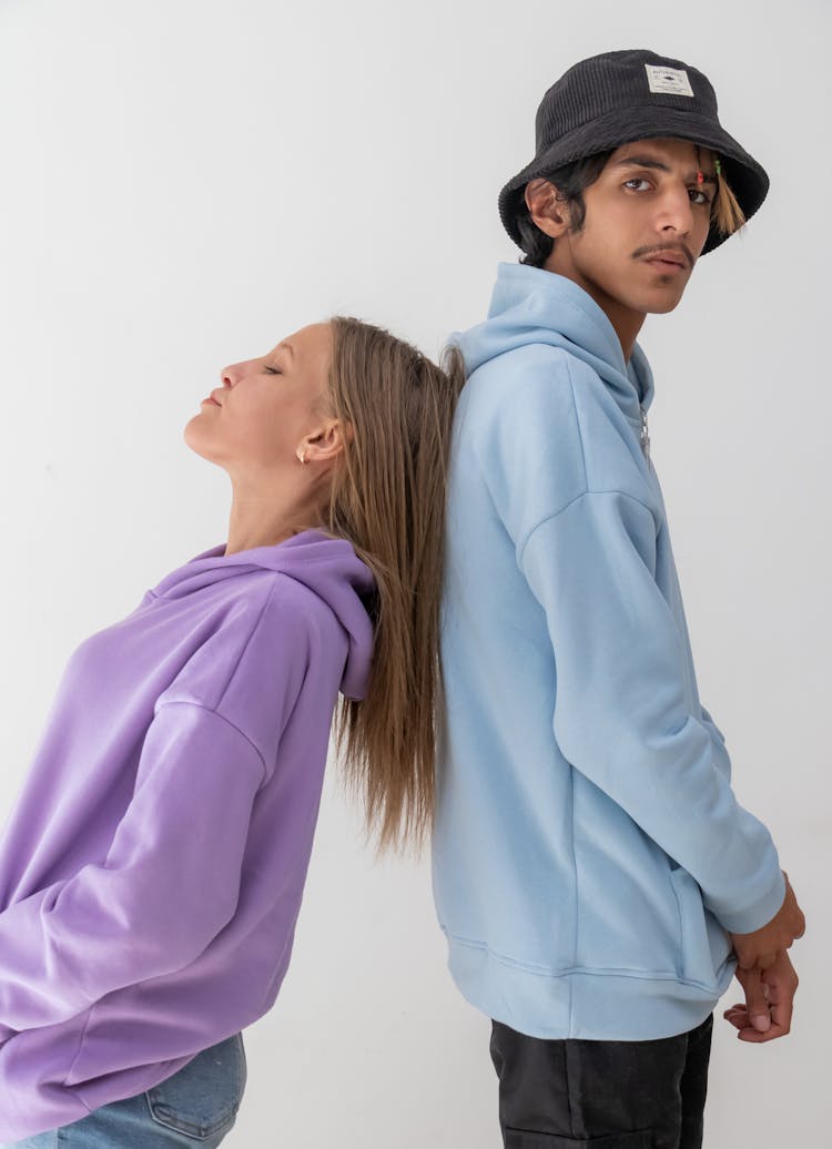 Woman And Man Posing In Hoodies