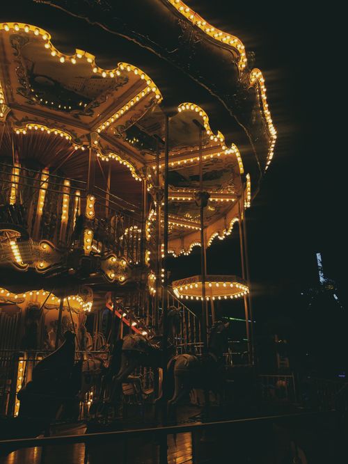 Free A beautifully lit carousel at night in a theme park, creating a magical atmosphere. Stock Photo
