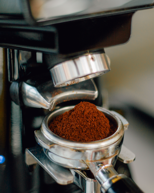 Free Detailed view of freshly ground espresso in a portafilter, ready for brewing. Stock Photo