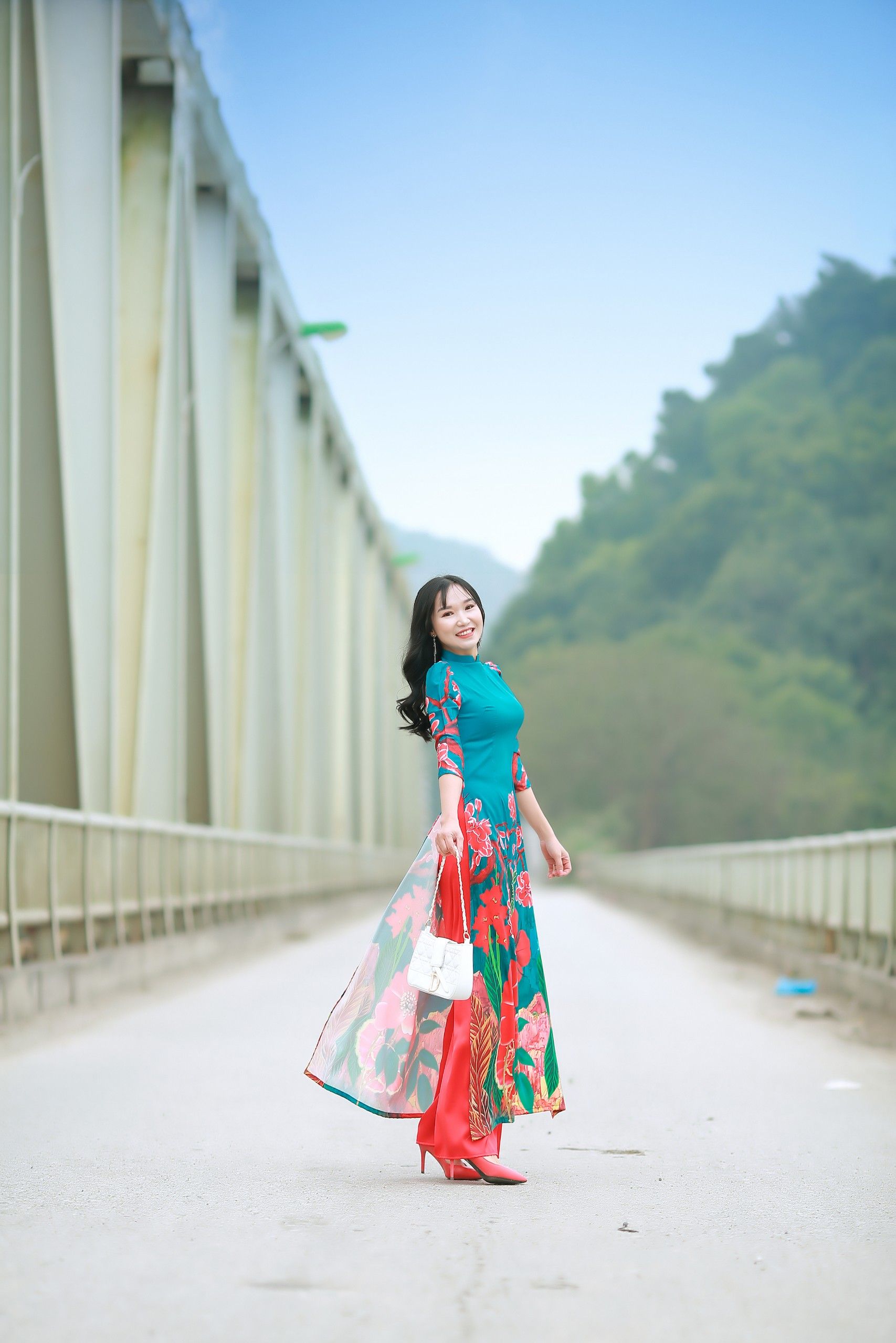 Young Woman in a Floral Dress Posing Outdoors · Free Stock Photo