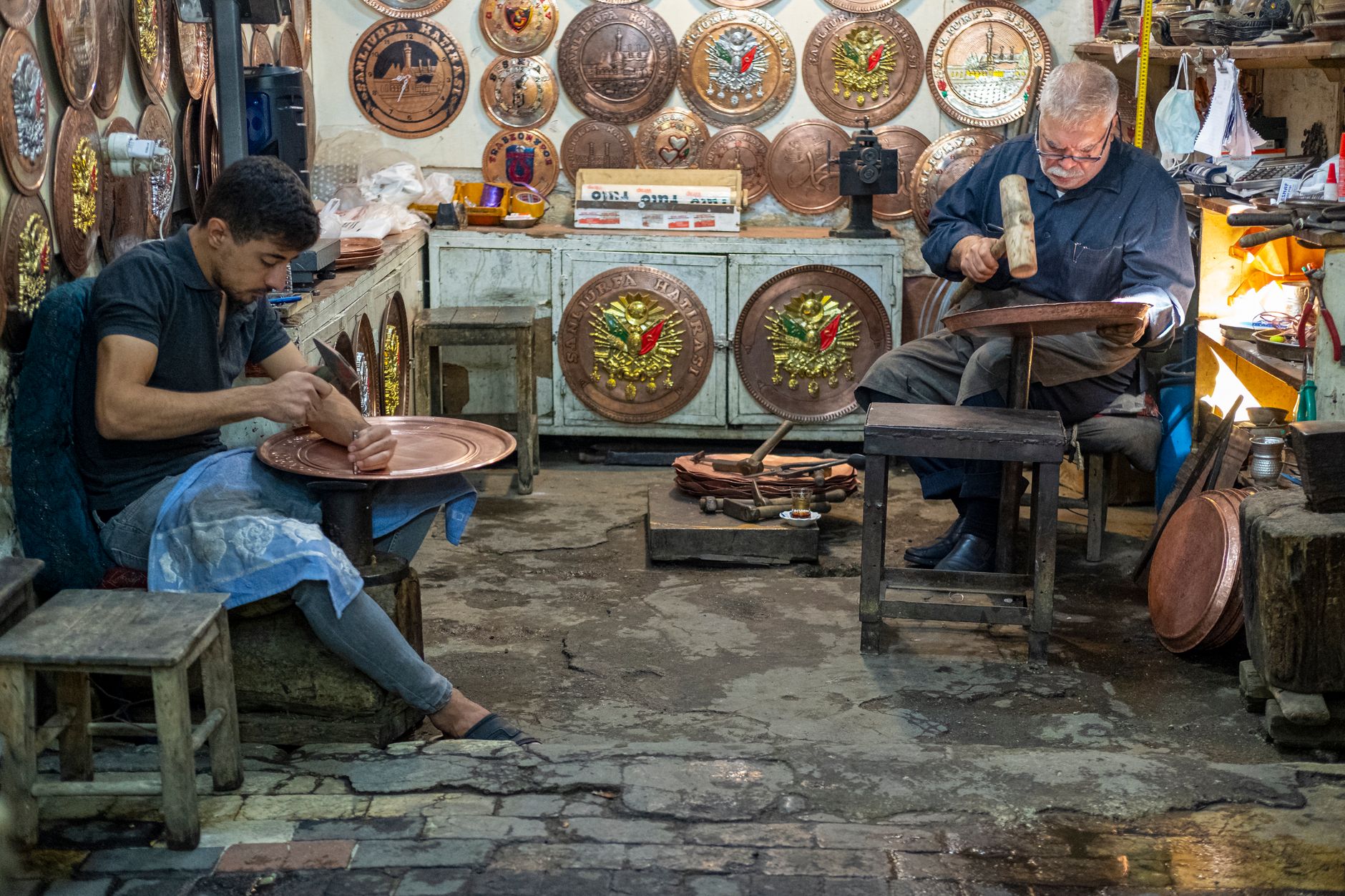 Artisans Sitting in a Workshop and Working on Cooper, Patterned Trays