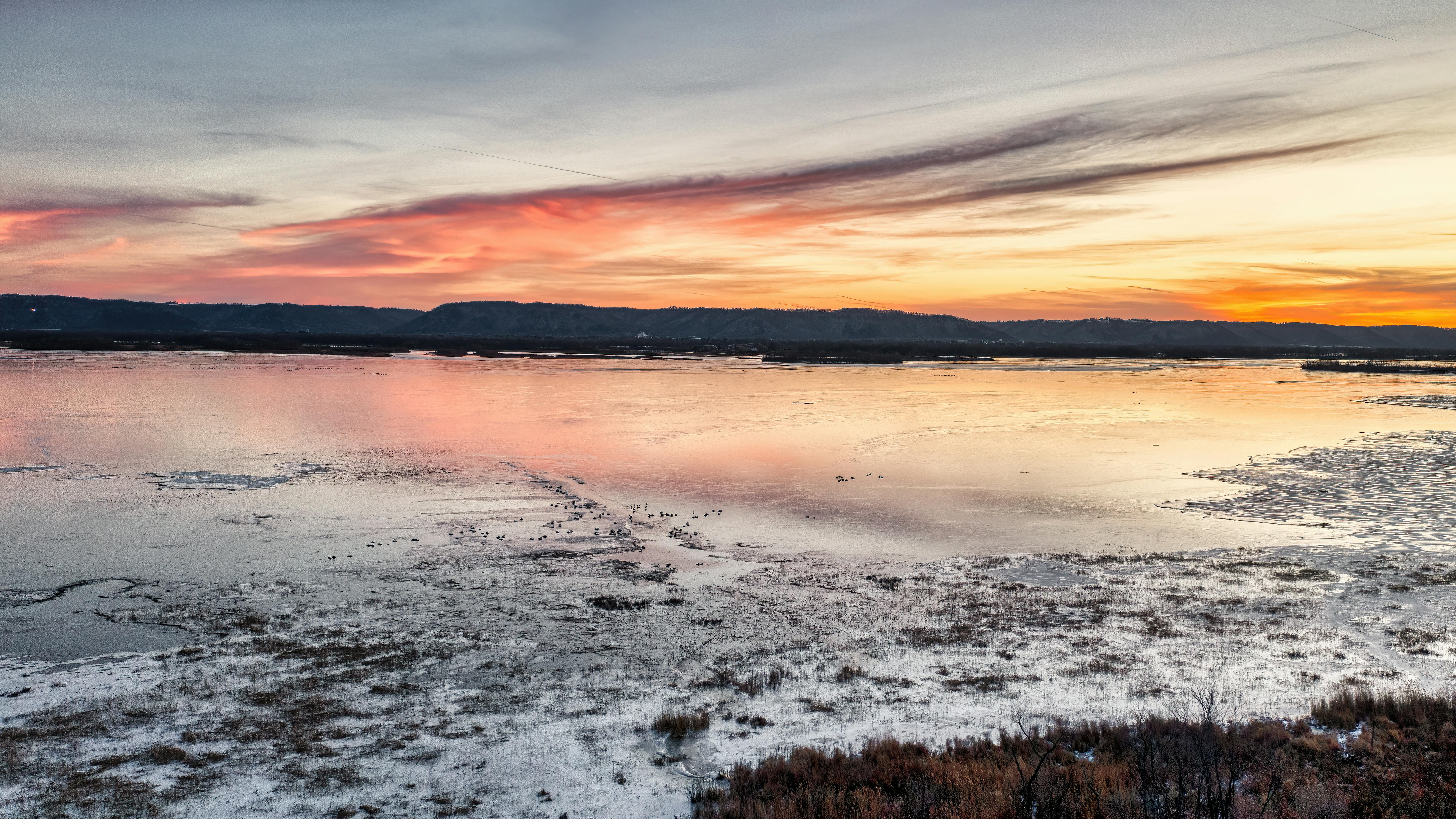 Beautiful sunset view over Weaver Lake, Minnesota with calm water and scenic sky.