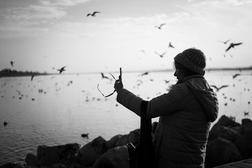 Grayscale Photo of a Woman Taking a Selfie