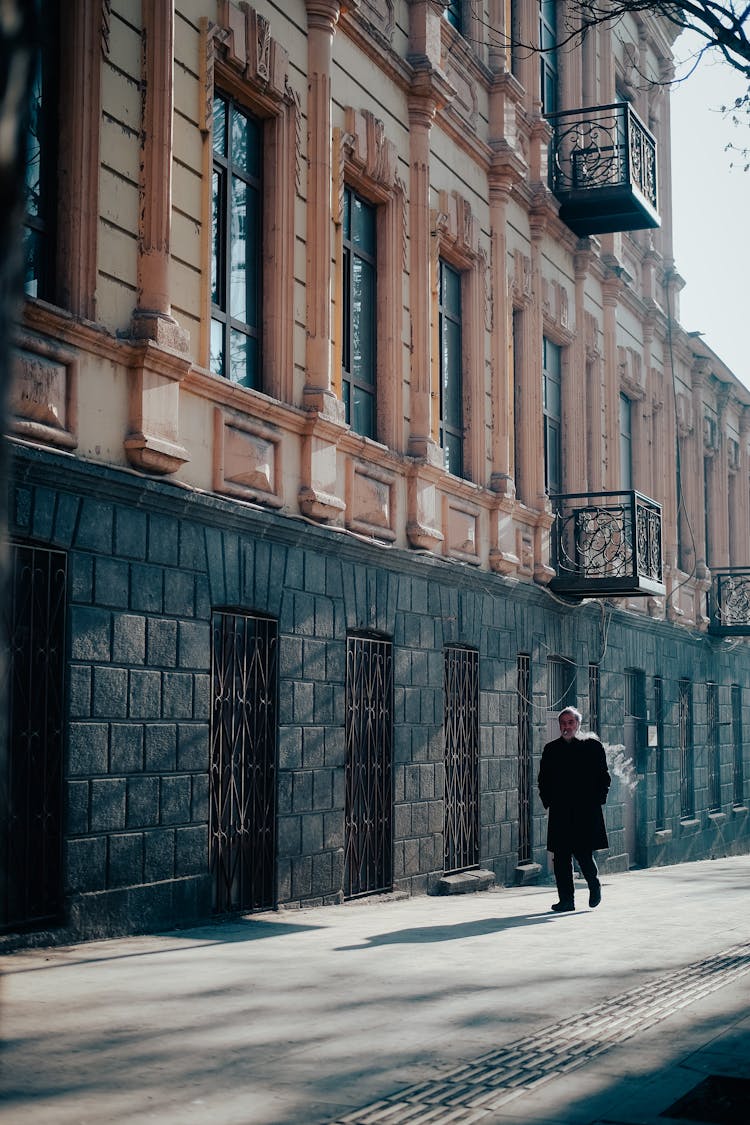 A Man Walking In A City