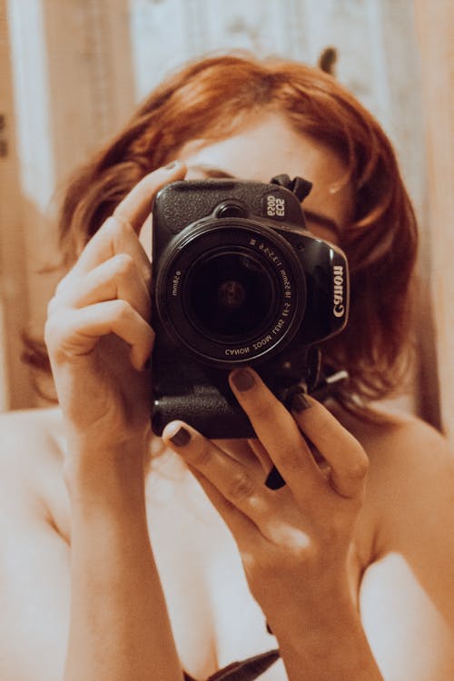 Woman Taking a Mirror Selfie with a Camera