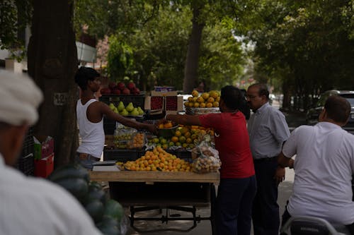 Man Selling Fruit on a Market by a Street