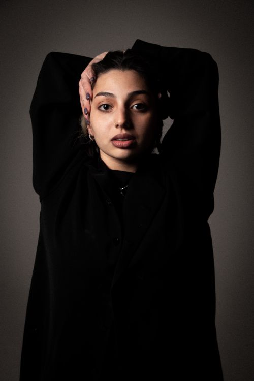 Free Captivating portrait of a stylish young woman in black clothing posing with charm. Stock Photo