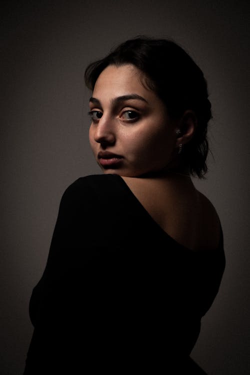 Woman in a Black Dress Posing in Studio 