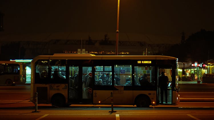 People Riding A Bus At Night 