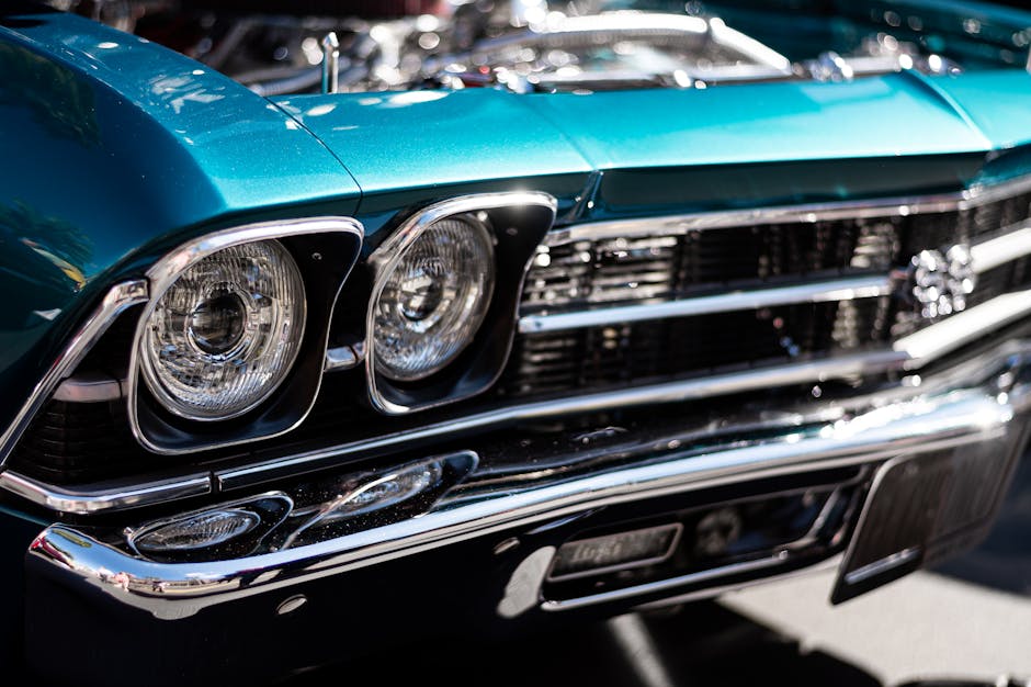 Close-up of a classic car at an event, captured in dramatic light.