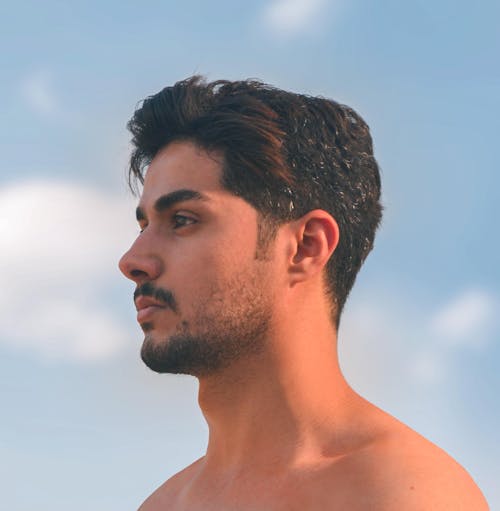 Photo of a Shirtless Handsome Man Against the Sky