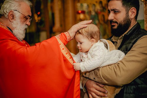 Priest Blessing a Child