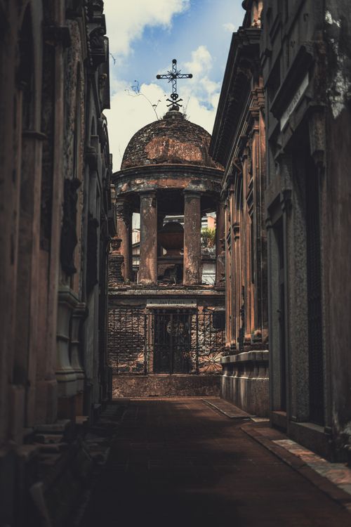Free A dramatic shot of an old, decaying structure in a narrow alley, emphasizing architectural decay. Stock Photo