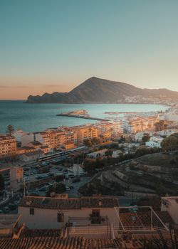 Stunning sunset view of Altea's harbor with mountains and sea from above.