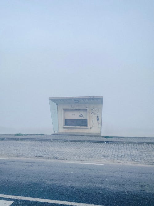 Abandoned Bus Stop by the Road in a Fog
