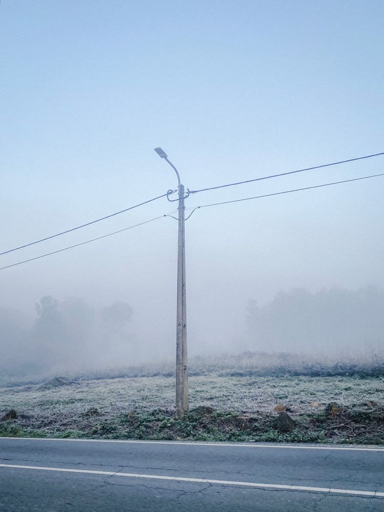 Electricity Lines In Fog Winter Landscape