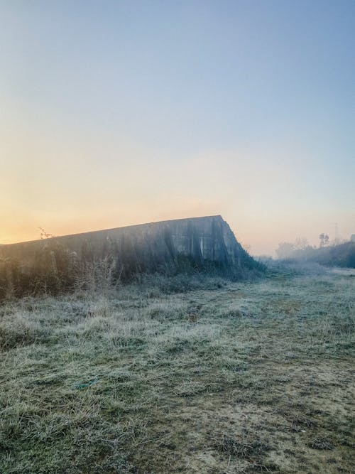 Free Cliff by Grass on the Cold Morning in a Fog by the Sunrise Stock Photo