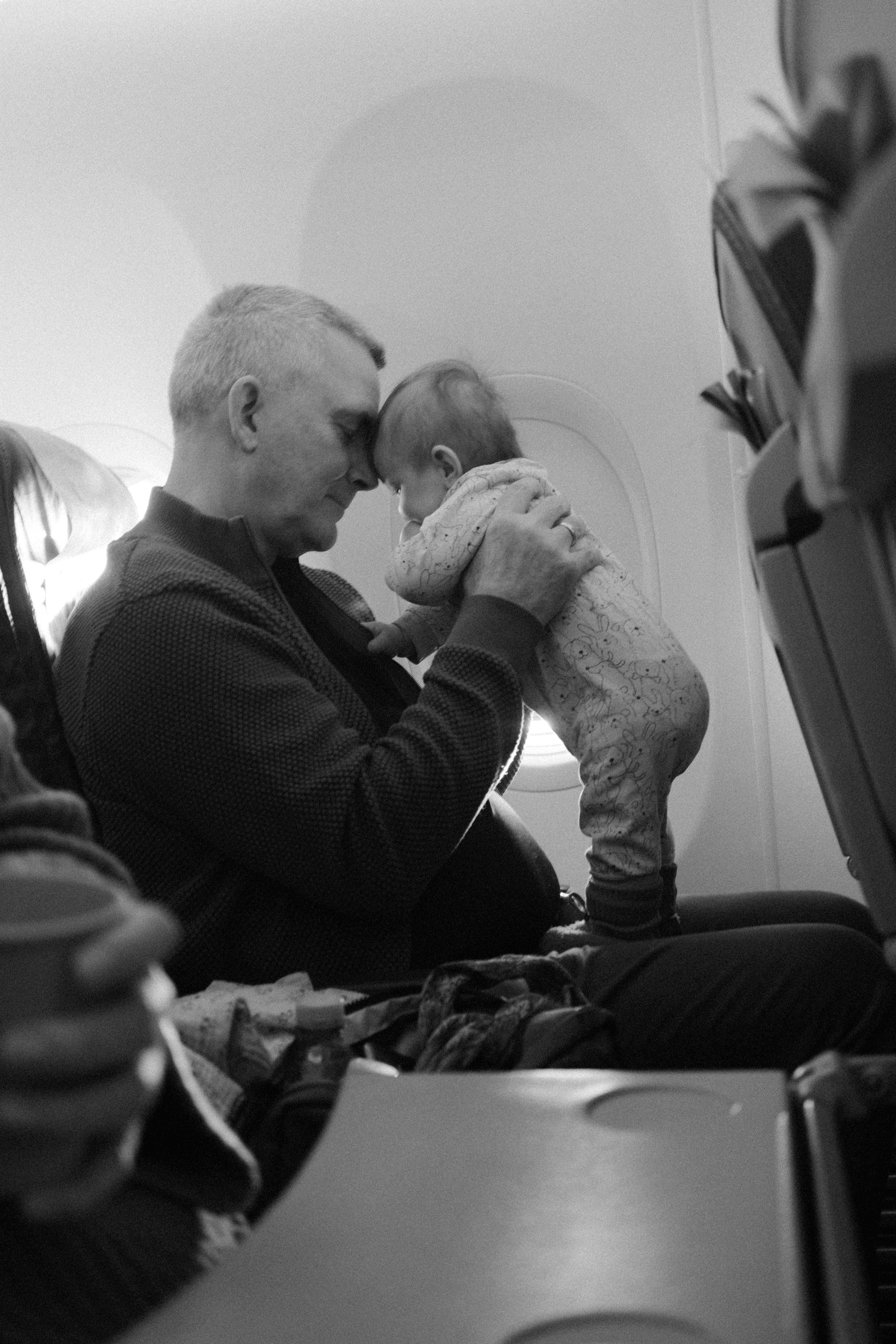 Parent holding a baby during an aeroplane journey