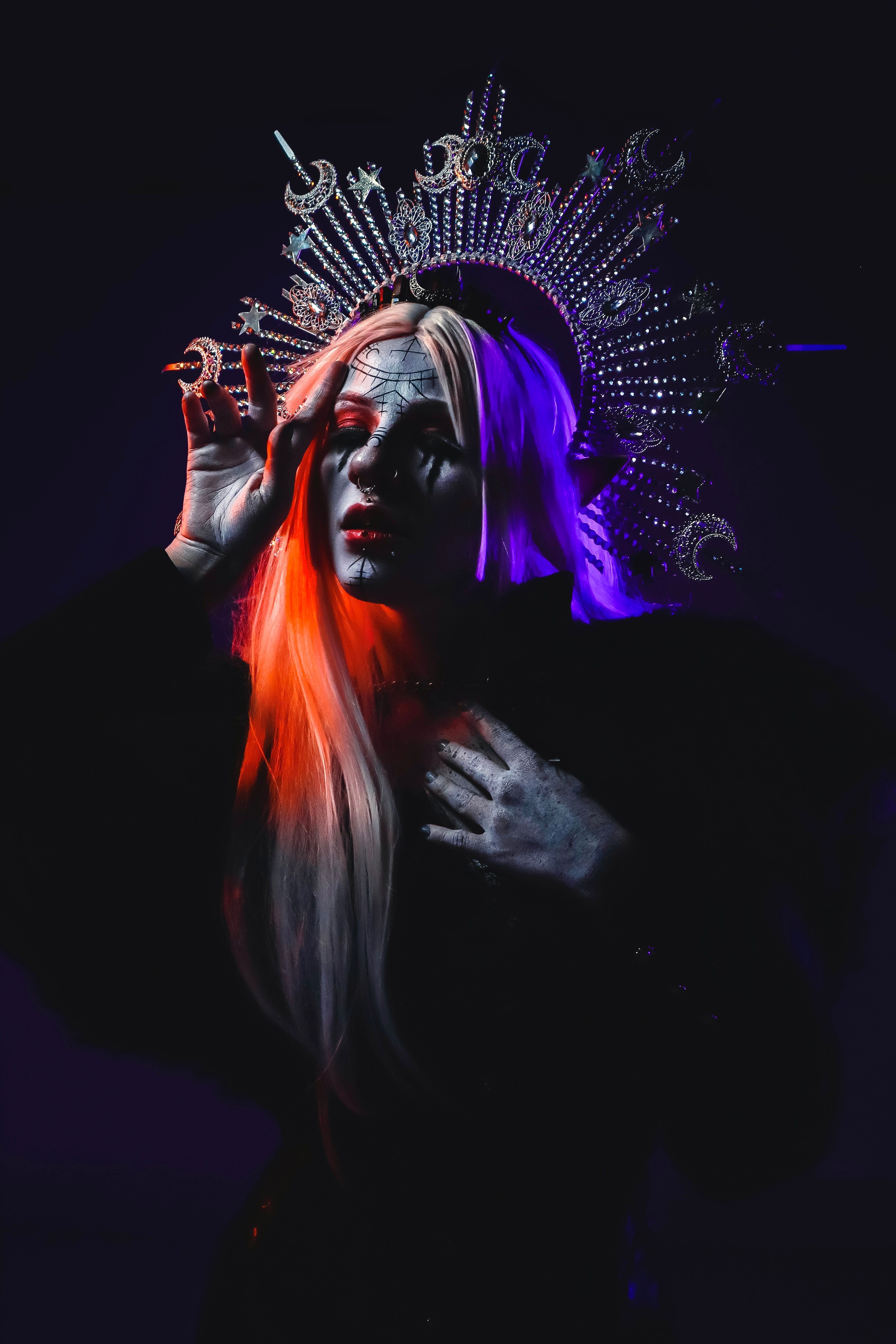 Striking gothic portrait of a woman in elaborate makeup and crown. Perfect for Halloween themes.