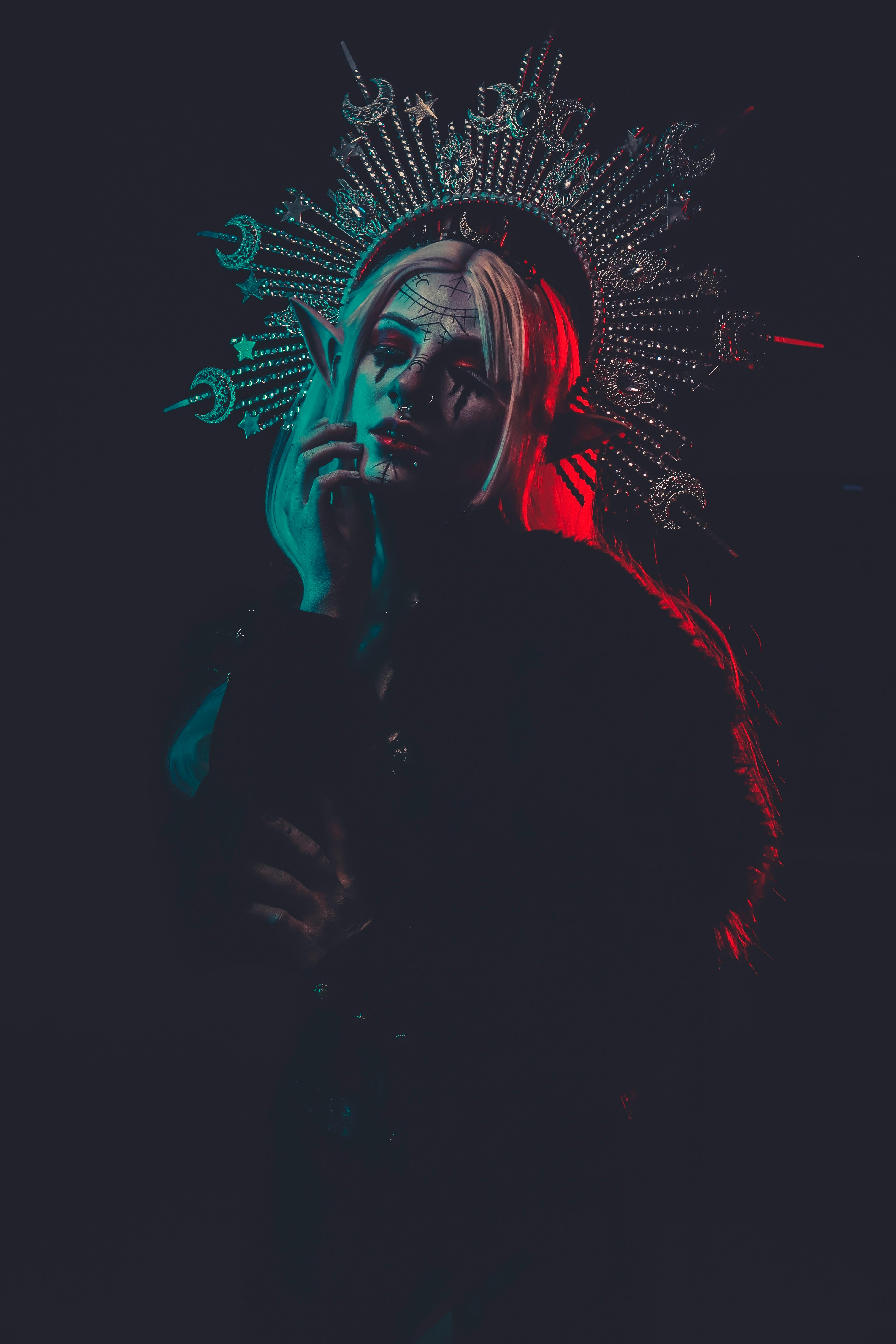 Mysterious portrait featuring a woman in dramatic lighting with an intricate headdress.