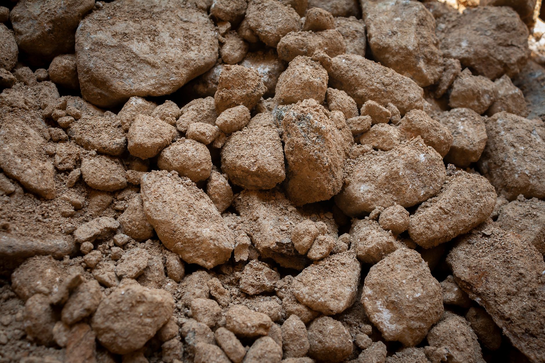 Detailed view of rough and dry soil texture, showcasing earthy tones and ruggedness.