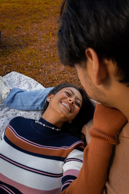 Free Smiling couple in a warm embrace enjoying a lovely day outdoors. Stock Photo