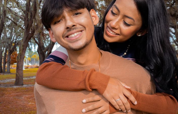 couple meeting for first date in coffee shop smiling and talking