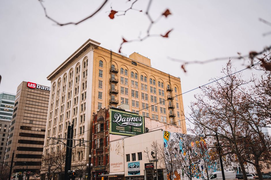 Captivating view of historic downtown buildings in an urban setting, with autumn trees framing the scene.
