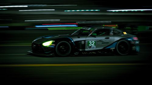 Free A high-speed car race at Daytona Beach, showcasing speed and competition under the night sky. Stock Photo