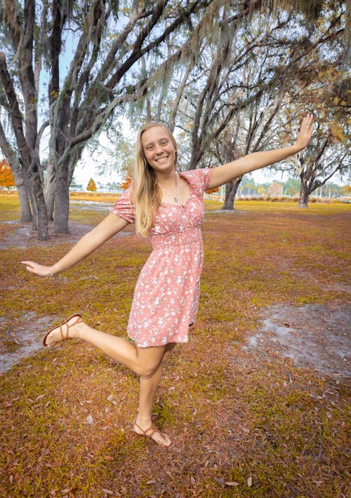 Smiling Blonde in Dress Posing in Park