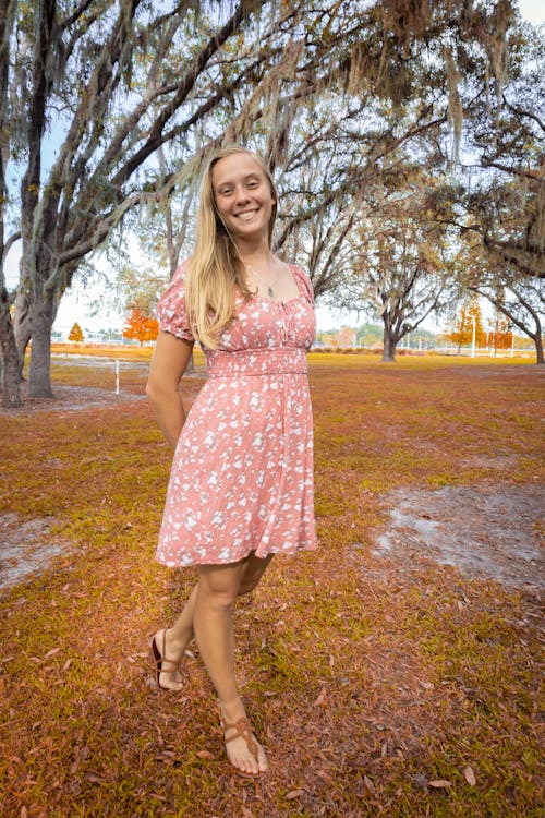 Smiling Blonde Woman in Pink Sundress