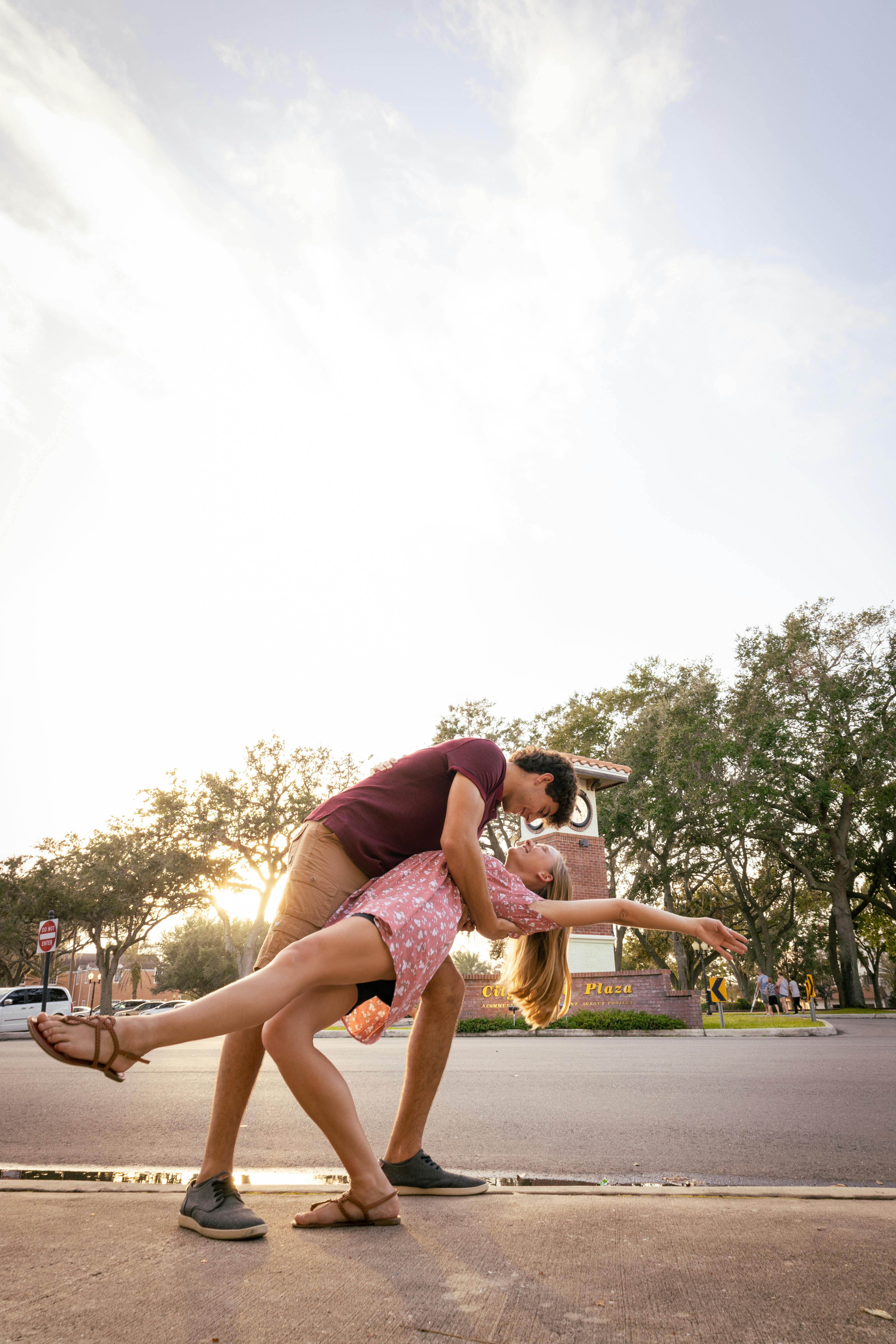 happy romantic couple dancing on sidewalk