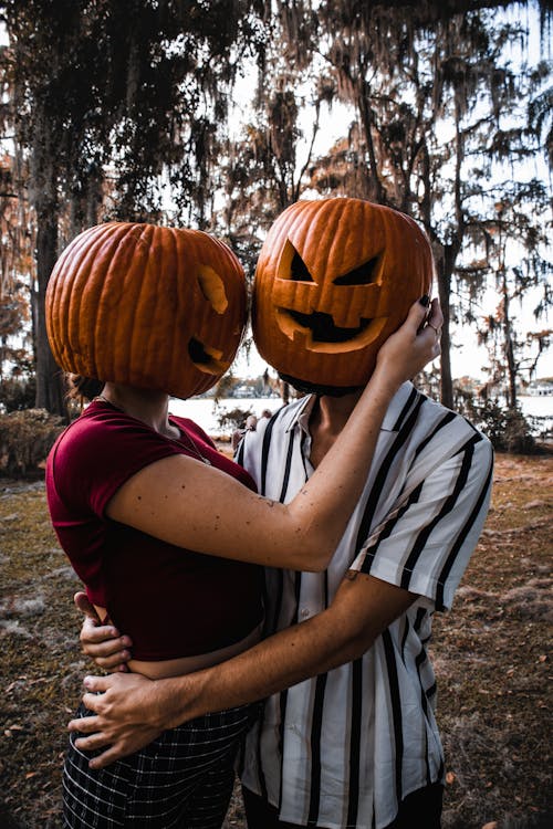 Hugging Couple with Pumpkins Heads