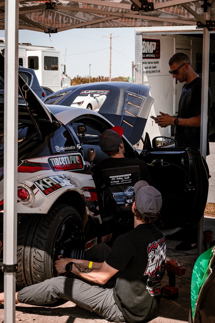 Mechanics Prepping The Race Car