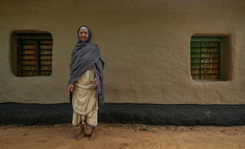 Elderly Woman in Dress and Headscarf
