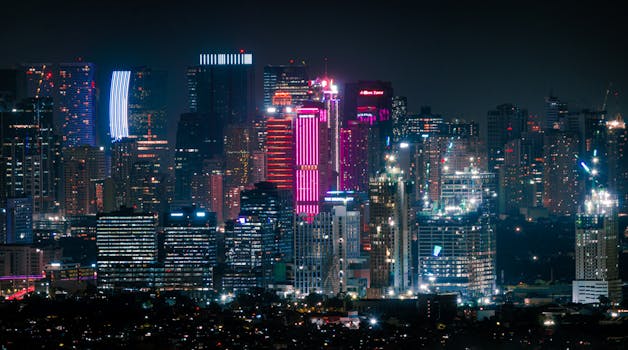 A breathtaking view of a bustling city skyline illuminated by vivid neon lights against the night sky.