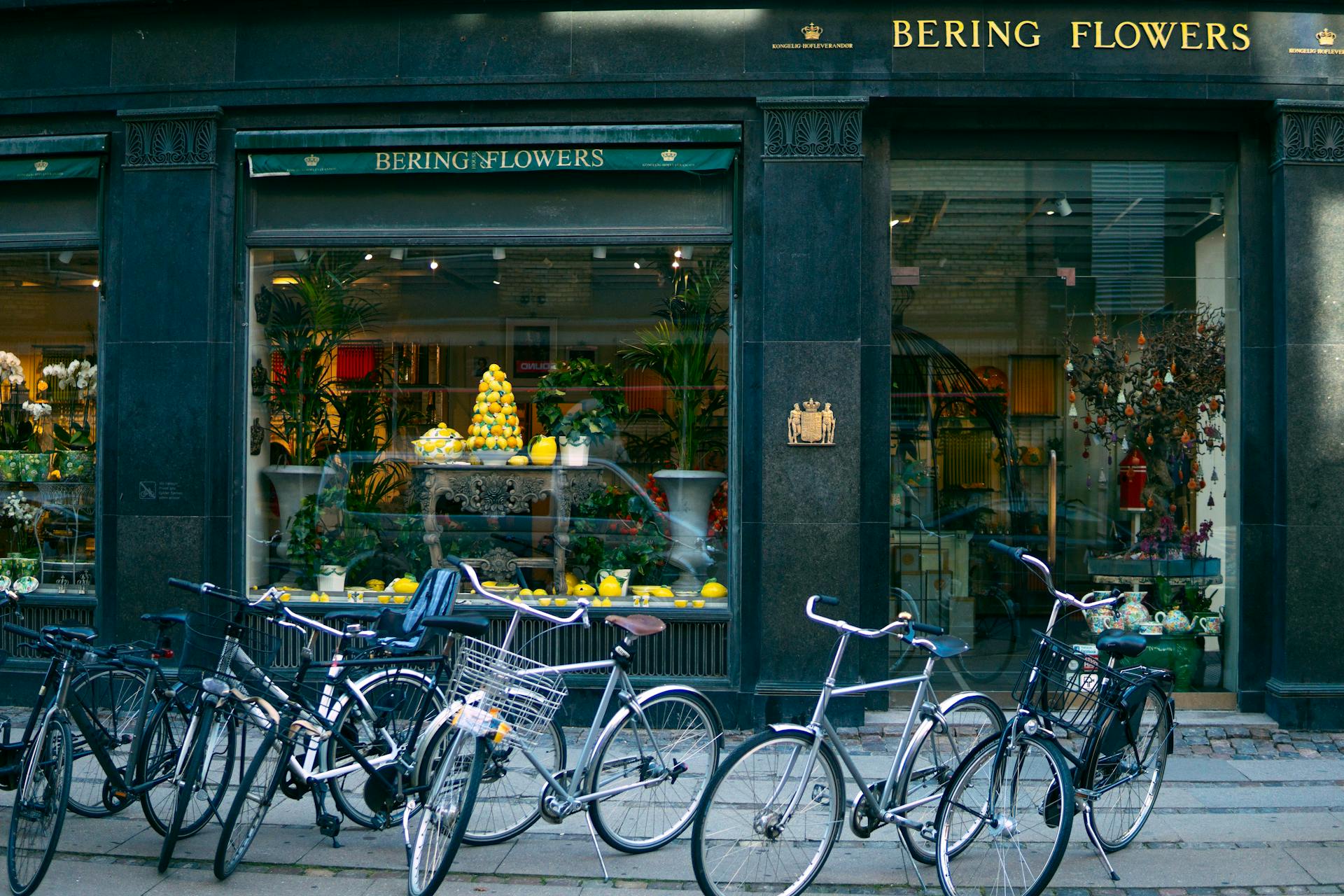 Several Assorted-color Bikes Parked in Front of Bering Flowers Facade