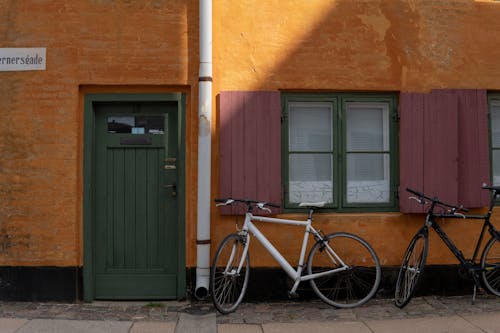 Free Bicycles Parked by Building Stock Photo