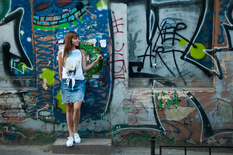 Woman Standing Near Gray And Blue Wall