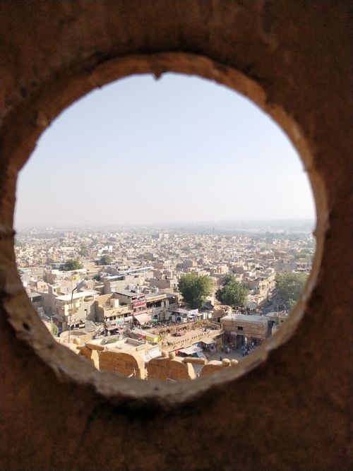 Jaisalmer townscape framed through a circular stone window