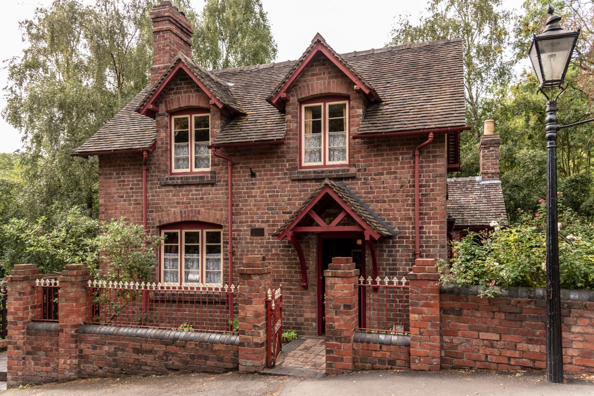 Weathered Victorian-style house against a gray sky, illustrative photo