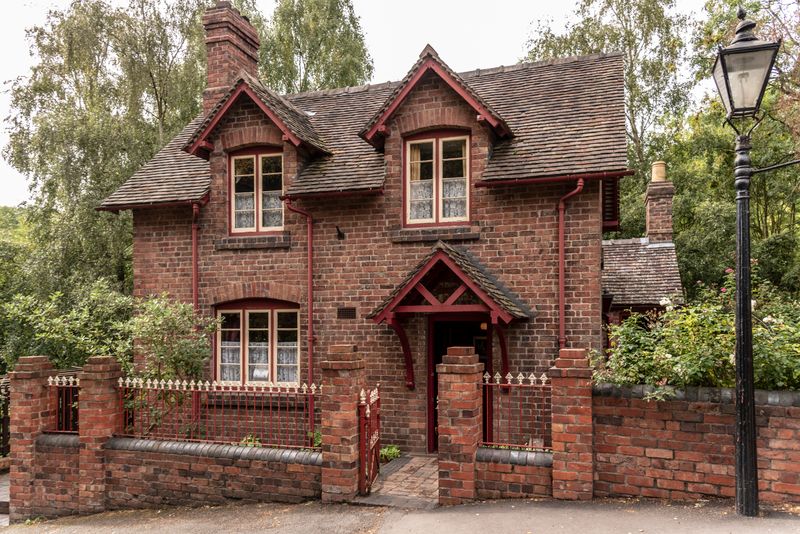 Weathered Victorian-style house against a gray sky, illustrative photo