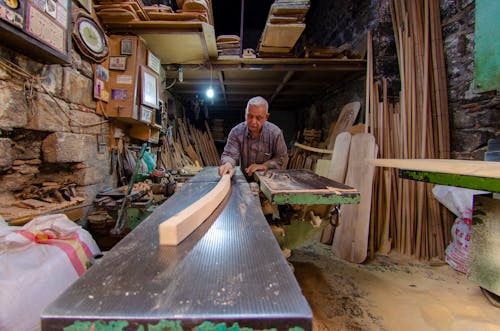Carpenter Cutting Wooden Piece